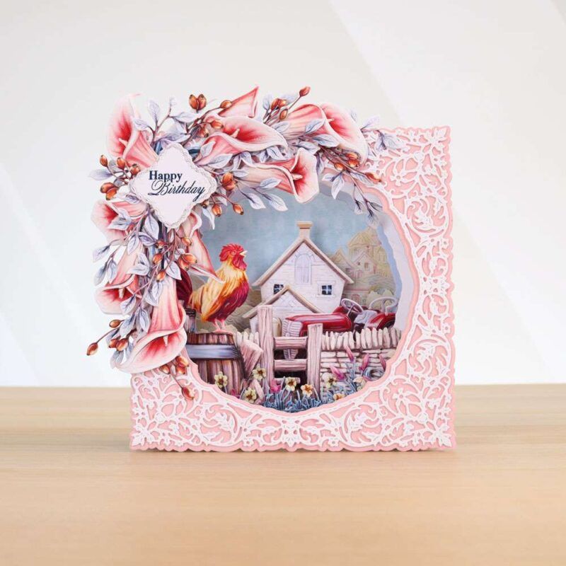 Card made using Beautifully Brisk Special Edition Vignette with a farm house in the background and a cockerel sounding the morning call. Calla Lily and other florals surround the top left corner of the card