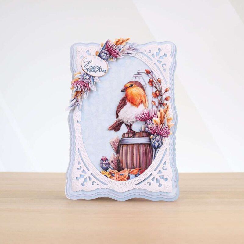 Card made using Beautifully Brisk Special Edition Vignette with a robin stood on a barrel as the main focal point, surrounded by different florals