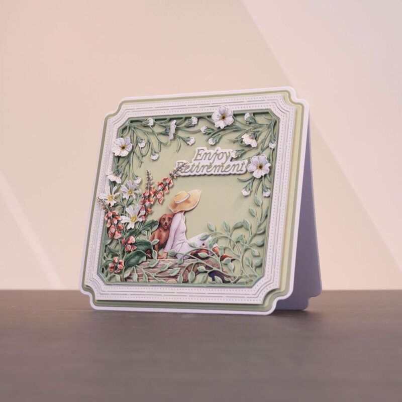 Card made using the Sunny Escape Special Edition Vignettes with a dog leaning on a woman sat down, surrounded by floral vines