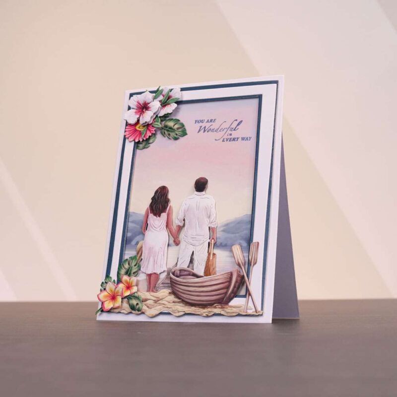 Card made using the Sunny Escape Special Edition Vignettes with a man and woman holding hands looking into the distance with a boat and ores close by
