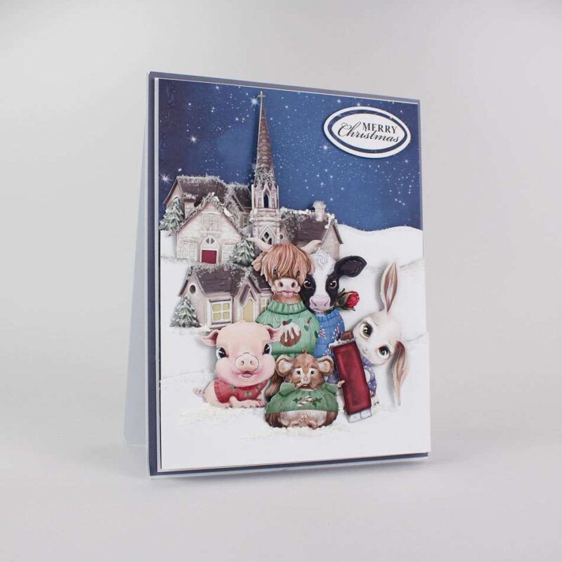 Card made using Christmas Jumper Special Edition Vignette with a selection of animals all wearing Christmas Jumpers in front of a house, surrounded by snow