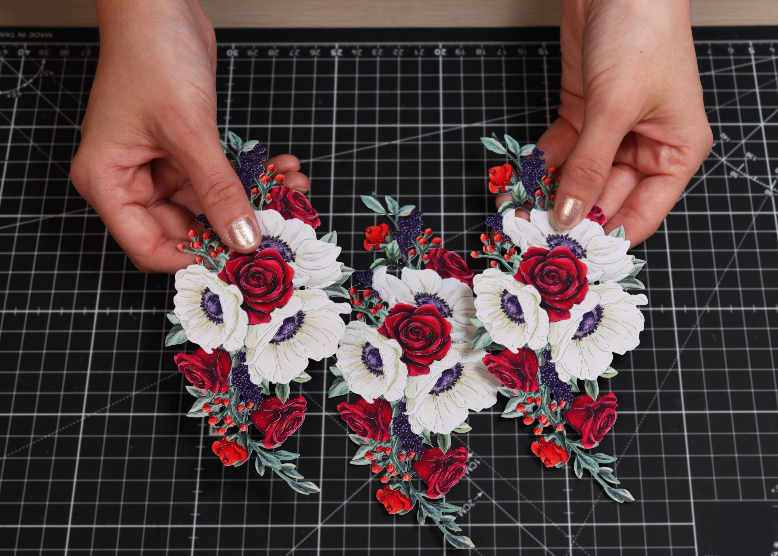 Hands showing pieces of die cut artwork