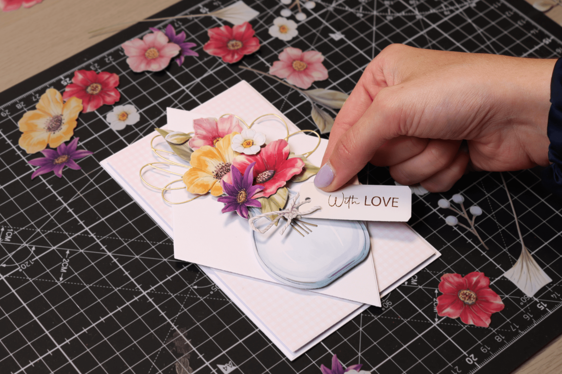 Hands placing a sentiment onto a layered card