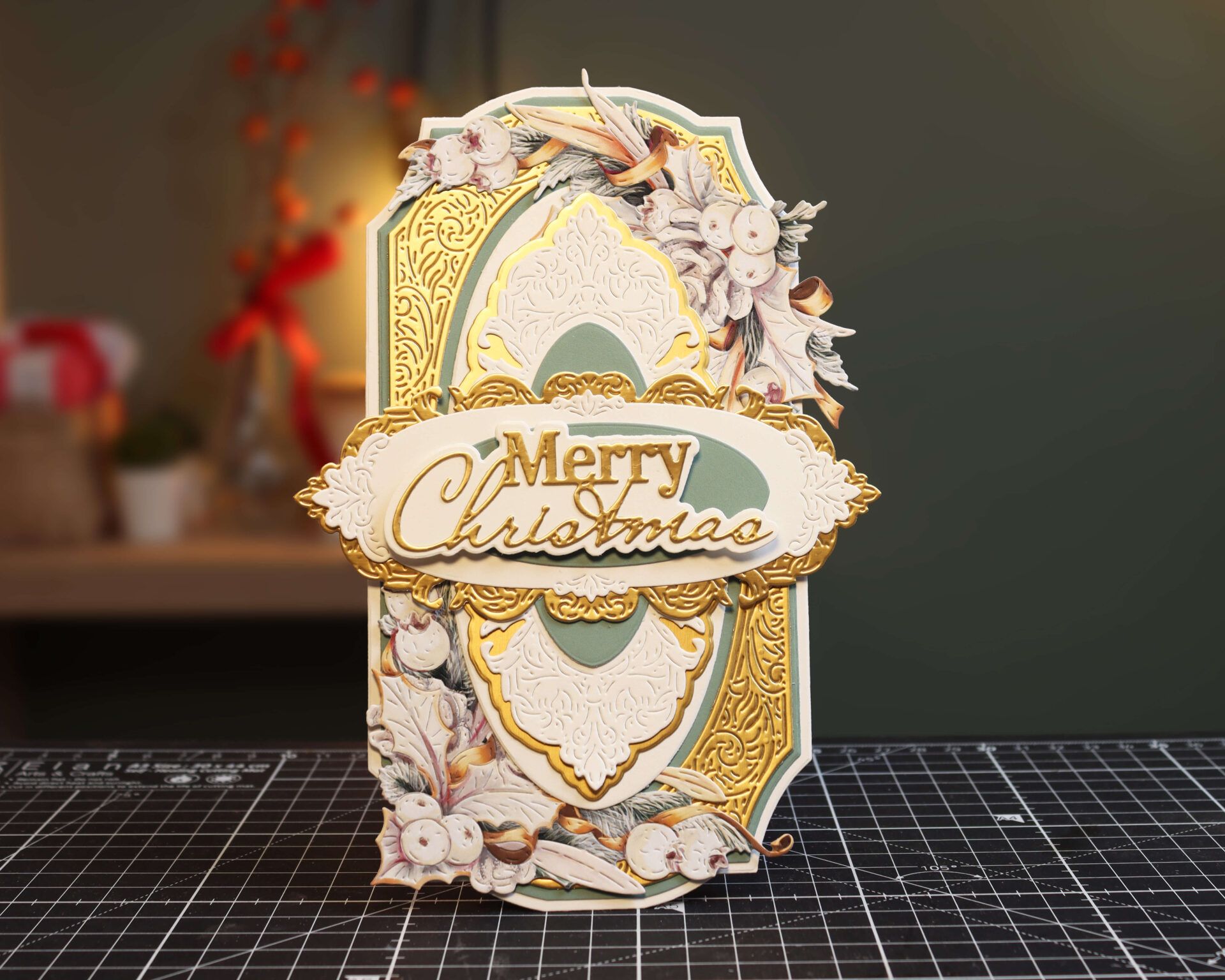 A photograph of a handmade Christmas card with gold elements