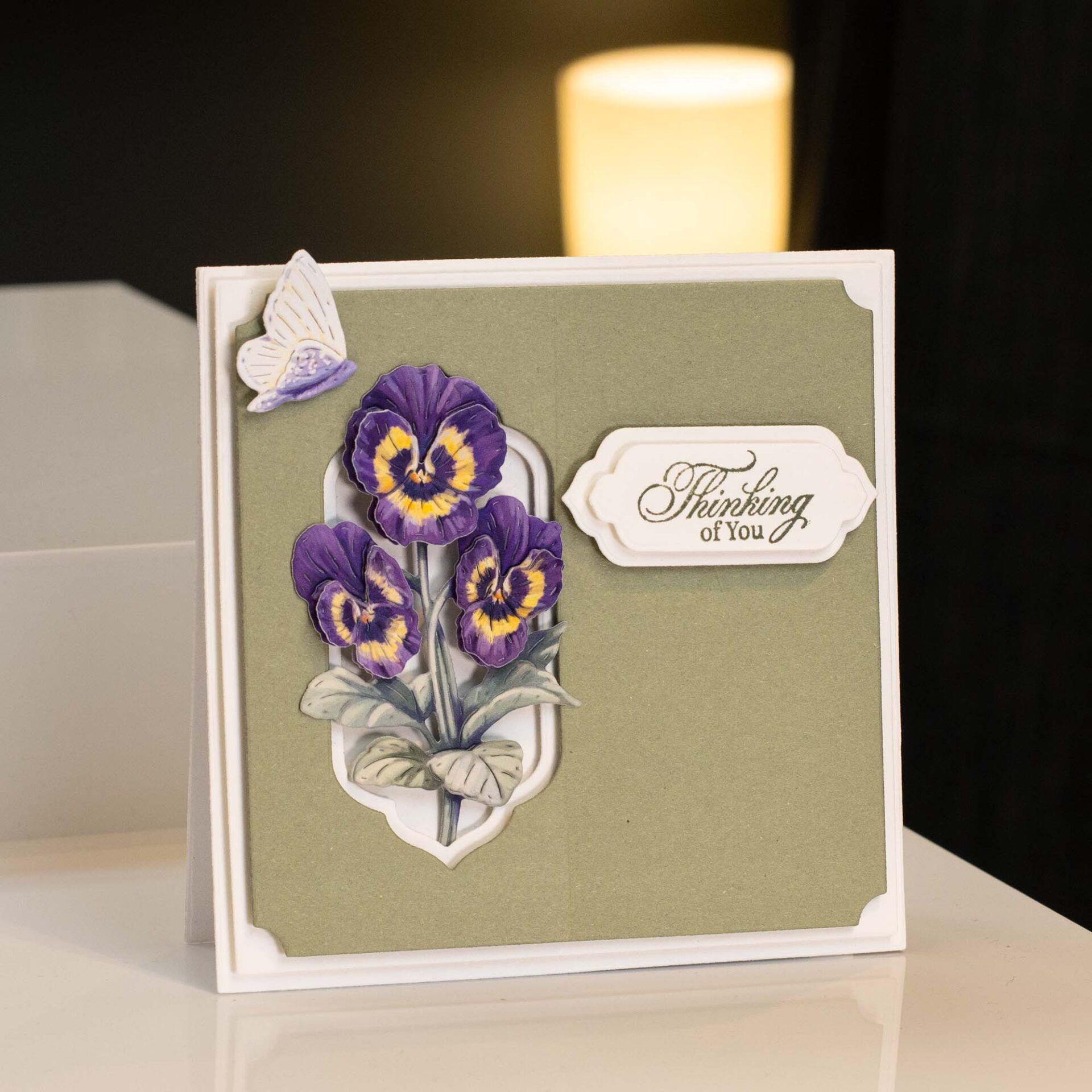 a card made with the precious pansies die cutting kit with green layers