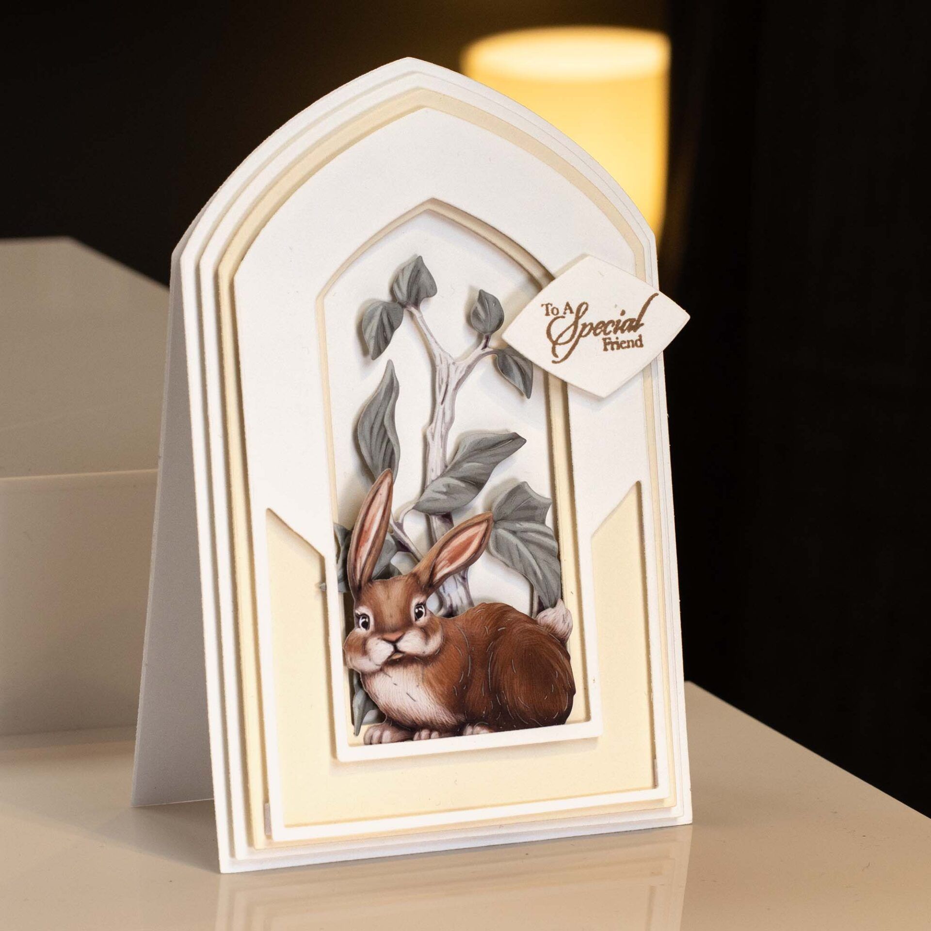 an arch shaped card with extra die cuts added in